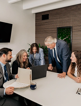 The Buckman & Castellano team meeting in the firm's office